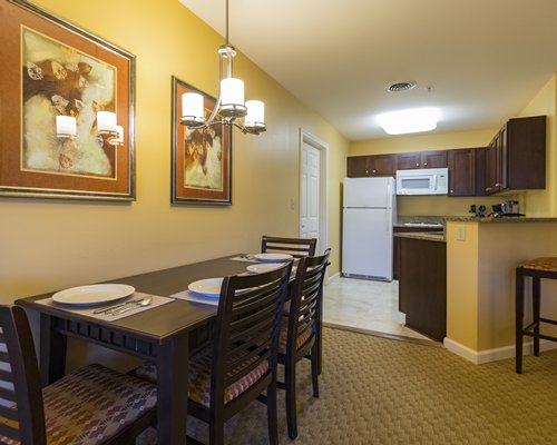 A well furnished living room with dining area and open plan kitchen.