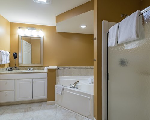 A bathroom with a shower and open sink vanity.