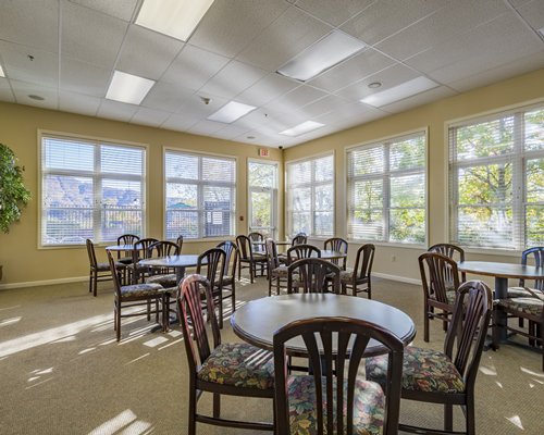 A well equipped indoor fitness center with an outside view.