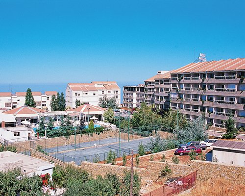 Exterior view of Ehden Country Club with outdoor tennis court.