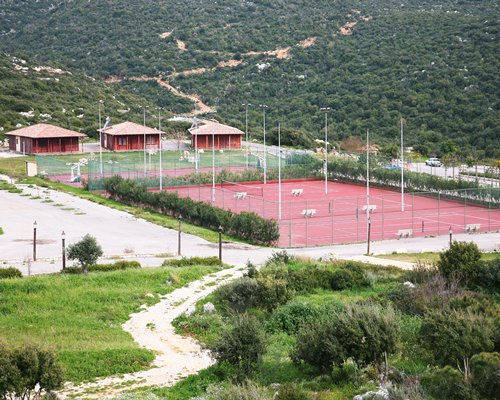 Scenic view of an outdoor recreation area with tennis court alongside multiple units.