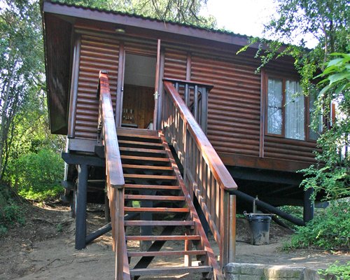 A unit with stairway at wooded area.