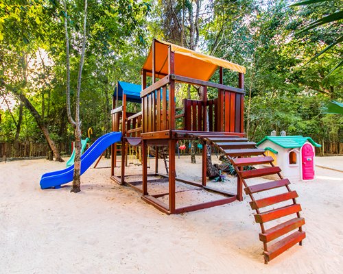 An outdoor kids play area on sand.