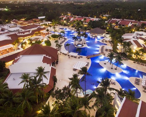 An aerial view of the resort with pool at night.