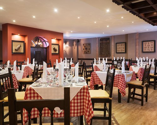 A restaurant interior with multiple dining tables.