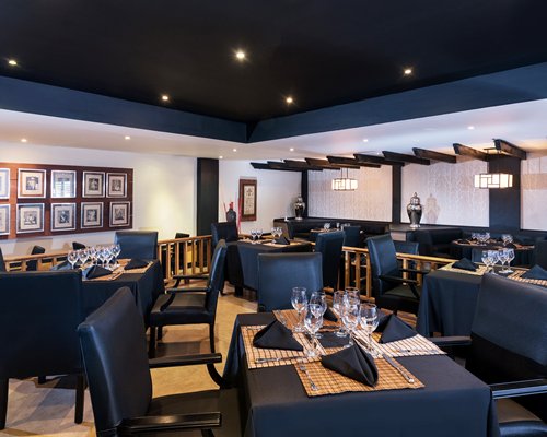 A restaurant interior with multiple dining tables.