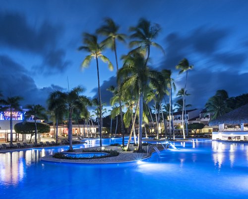 View of exterior with landscaped pool at night.