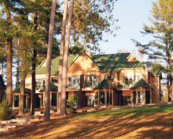 An exterior view of a resort unit with trees.