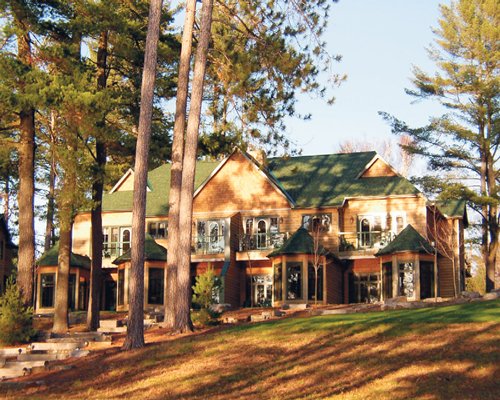 An exterior view of a resort unit with trees.