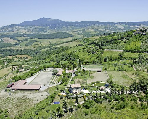 An aerial view of Il Poggio surrounded by wooded area.