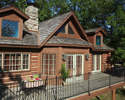 Exterior view of a unit with stairway at Bluegreen Wilderness Club at Big Cedar surrounded by wooded area.