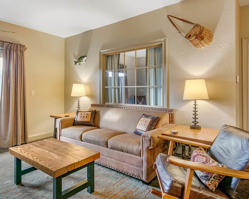 An open plan living and dining with fireplace alongside balcony.