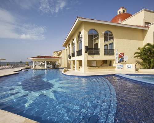 Exterior view of All Ritmo Cancun Resort outdoor swimming pool.