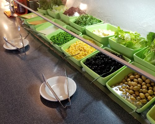A well furnished indoor fine dining restaurant with a television and an outside view.
