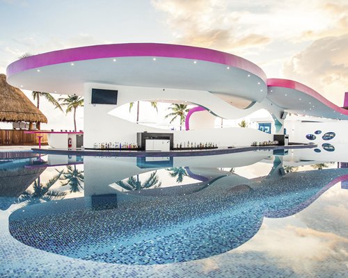 An outdoor swimming pool with swim up bar.