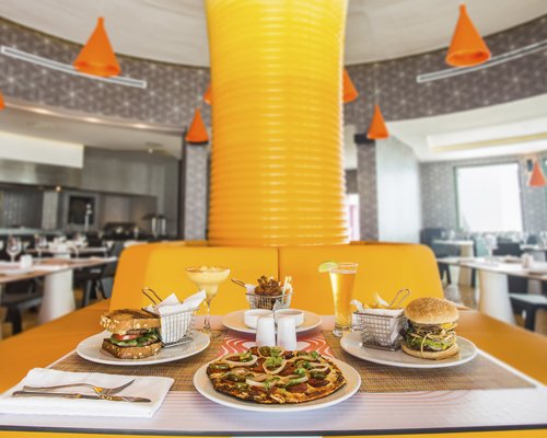 Food items and beverages on the table at an indoor restaurant.