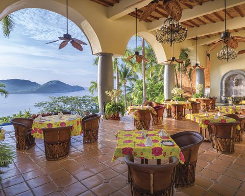An indoor fine dining area at the resort with the water view.