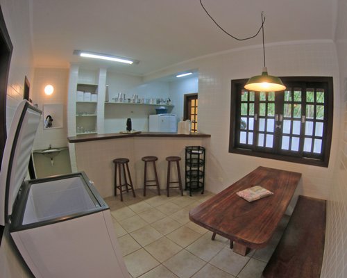 A well equipped kitchen with a breakfast bar and an outside view.