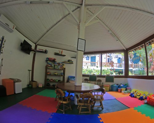 An indoor recreation room for kids with a television.