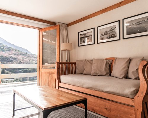 A well equipped kitchen with a breakfast bar alongside television.