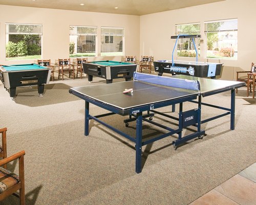An indoor recreation room with pool tables.