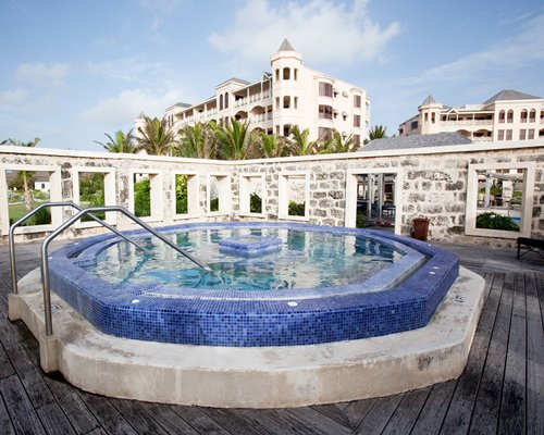 Scenic an outdoor hot tub alongside multi story condos.