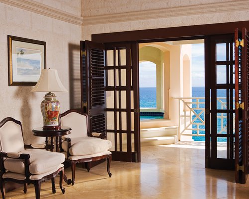 A well furnished living room alongside the ocean.