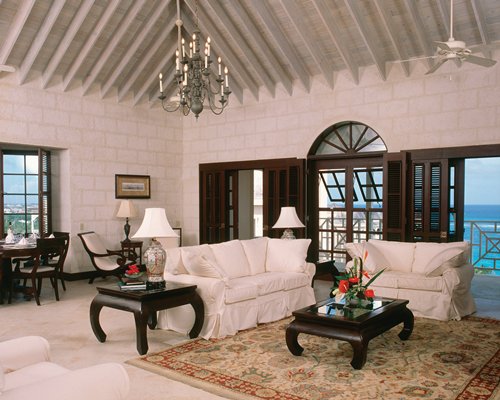 A well furnished living room with queen pull out sofa and dining area.