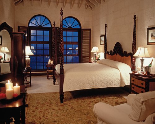 A well furnished bedroom with a king bed and an outside view.