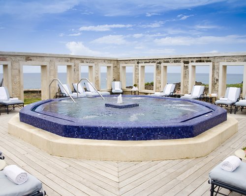An outdoor swimming pool with a waterfront view.
