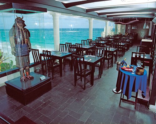 A well furnished indoor fine dining restaurant with a waterfront view.