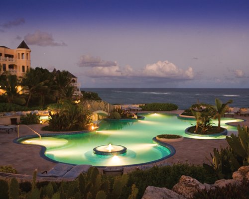 An outdoor swimming pool alongside resort condos.