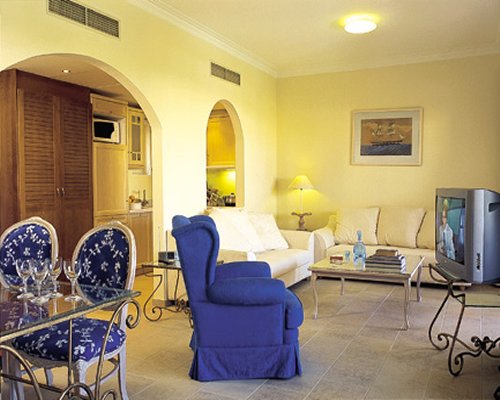 An open plan living room with double pullout sofa and dining area.