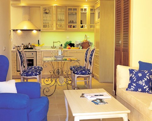 A well furnished living room with open plan kitchen and dining area.