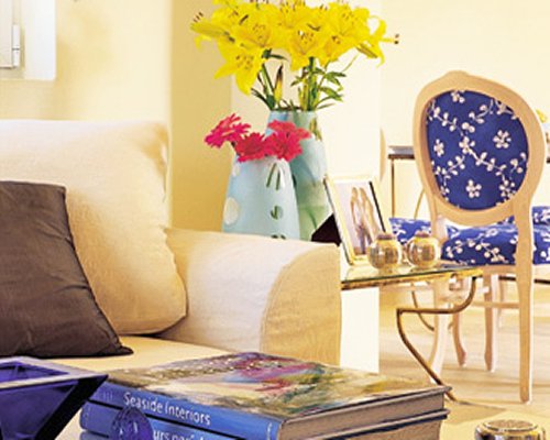 A well furnished living room with a book on a table.