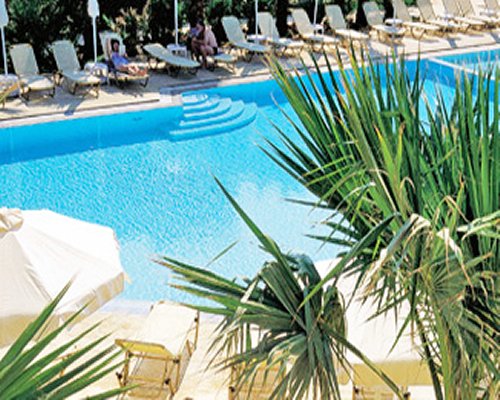 An outdoor swimming pool with chaise lounge chairs.
