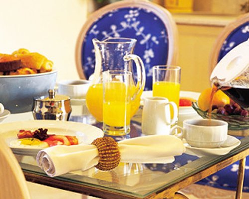 A view of juices kept on the glass topped dining table.