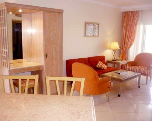 A well furnished bedroom with two twin beds and balcony.