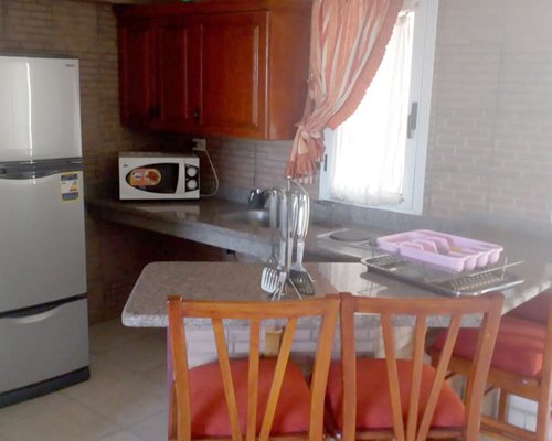 A well furnished bedroom with television alongside an outdoor view.