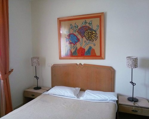 A well furnished bedroom with two beds and a balcony.