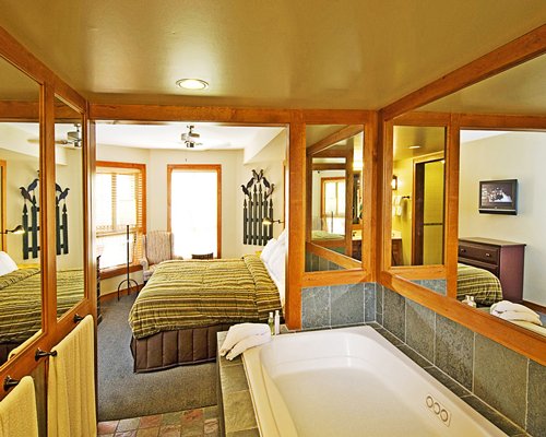 An open plan bedroom with a bathtub.