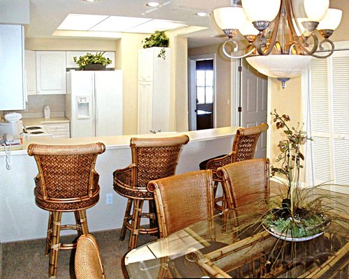 A well equipped kitchen with breakfast bar and glass top dining area.