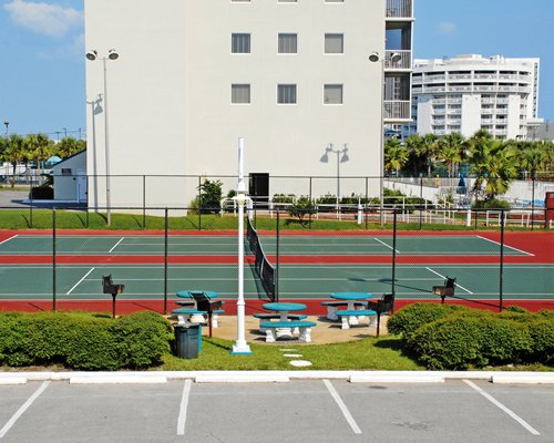 Outdoor recreation area with tennis court.