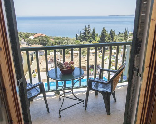 Balcony with patio furniture and sea view.