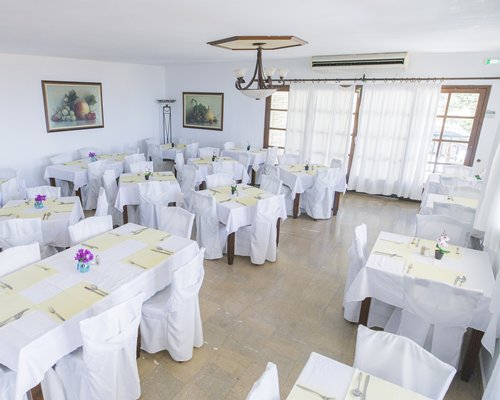 Indoor restaurant at Corfu Residence with outside view.