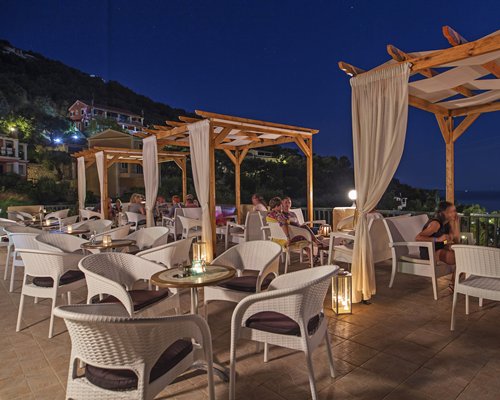 A night view of a large outdoor dining area.