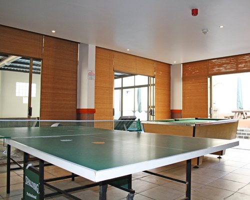 An indoor recreational area with ping pong and pool table.