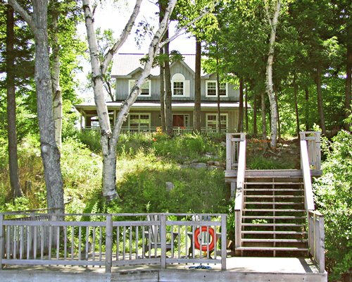 A unit surrounded by wooded area with a stairway.