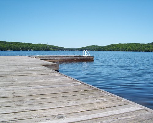 A wooden pier leading to a lakefront.
