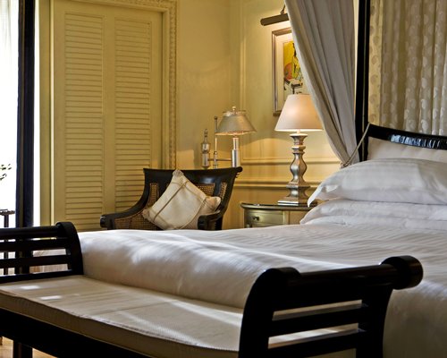 A well furnished bedroom with an outside view.